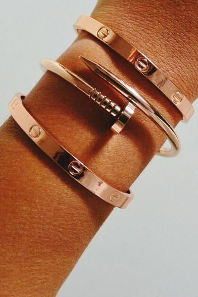 cartier love bracelets on a woman's arm