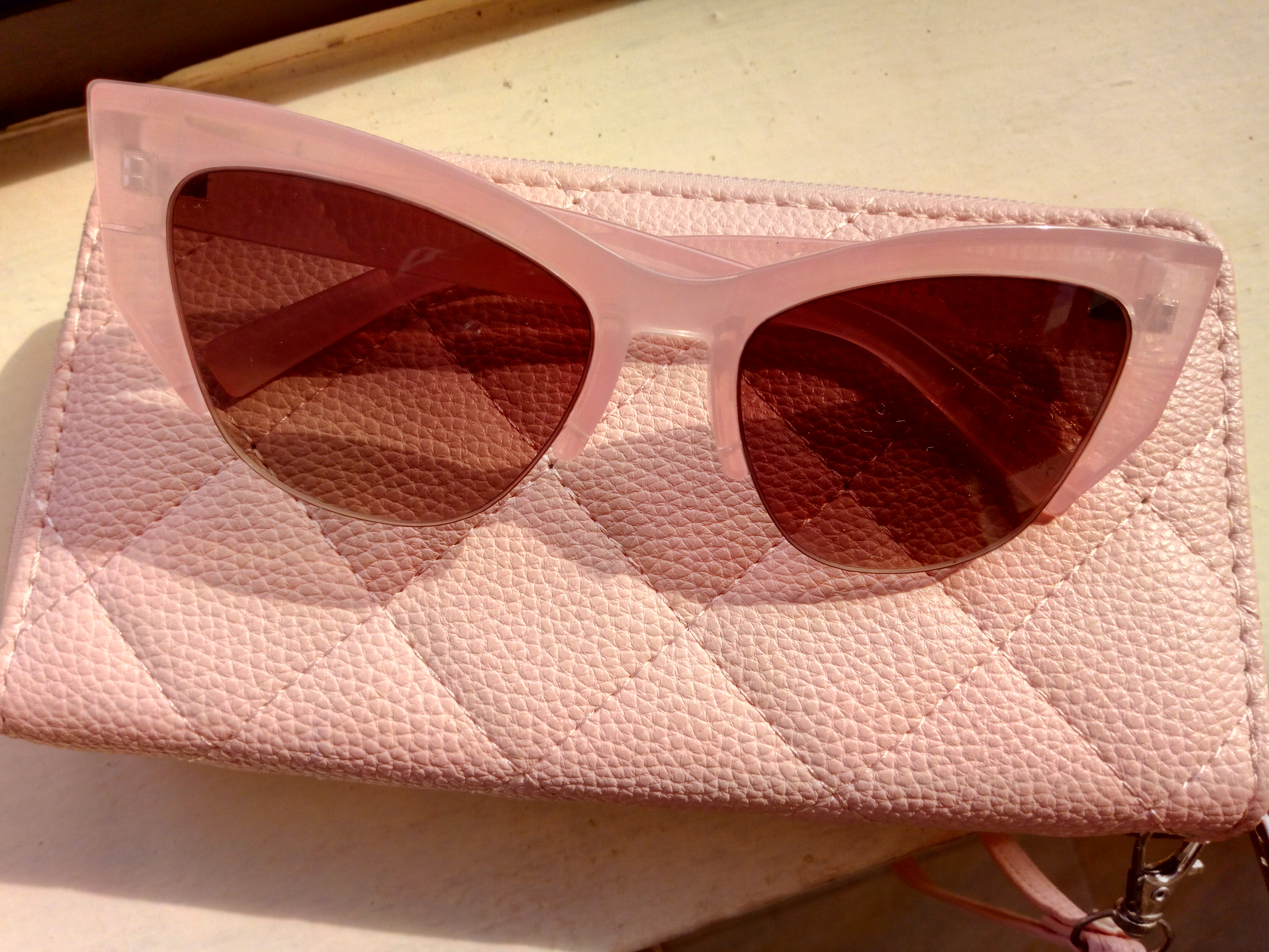pink sunglasses and wallet